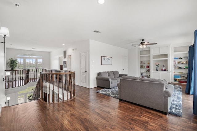 living room with ceiling fan and dark hardwood / wood-style flooring