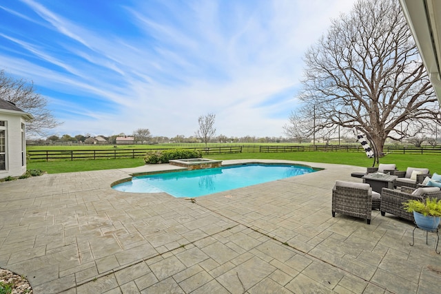 view of pool with a patio, a yard, a rural view, and an in ground hot tub