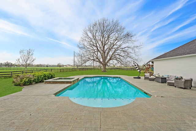 view of pool featuring an in ground hot tub, a rural view, a patio area, and a lawn