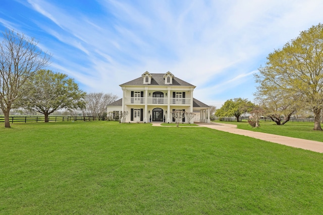 view of front of property featuring a balcony, a front lawn, and a porch