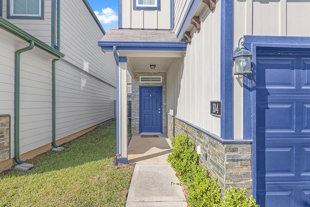 property entrance with a lawn