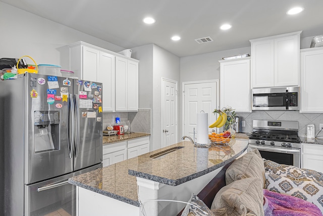 kitchen with white cabinets, stainless steel appliances, and sink