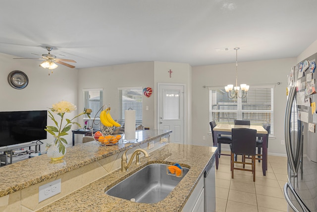 kitchen with sink, hanging light fixtures, a healthy amount of sunlight, and stainless steel appliances