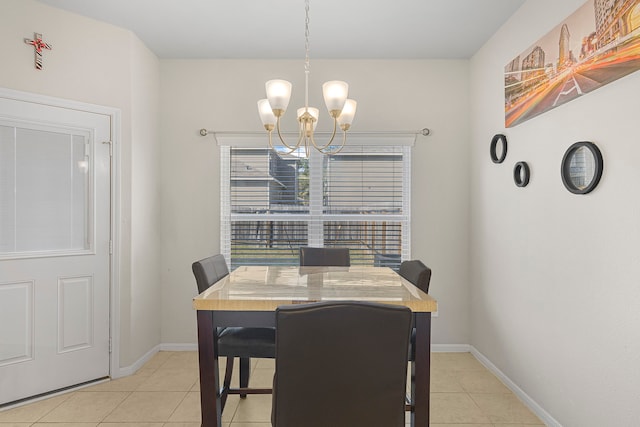 tiled dining room featuring an inviting chandelier