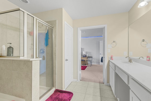 bathroom with tile patterned floors, vanity, and a shower with shower door