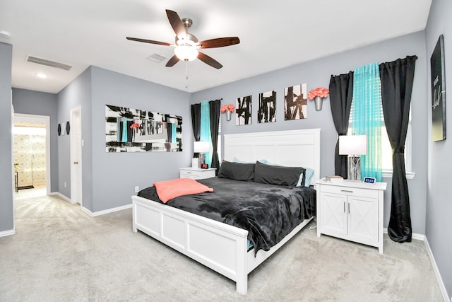 carpeted bedroom featuring ceiling fan and multiple windows