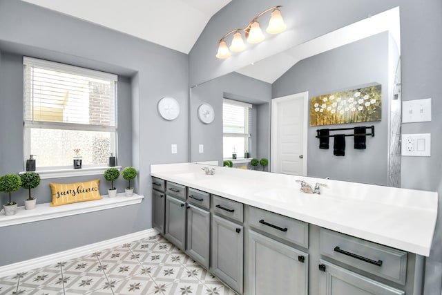 bathroom with vanity and lofted ceiling