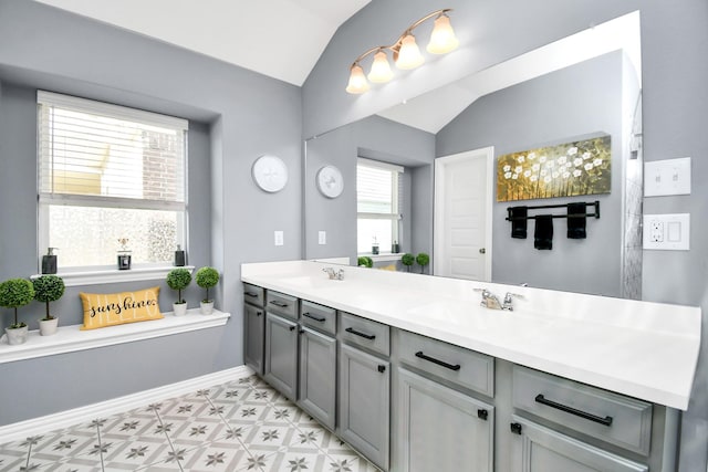 12810 Ilderton Dr, Humble, TX 77346 - full bath with lofted ceiling, double vanity, tile patterned floors, and baseboards