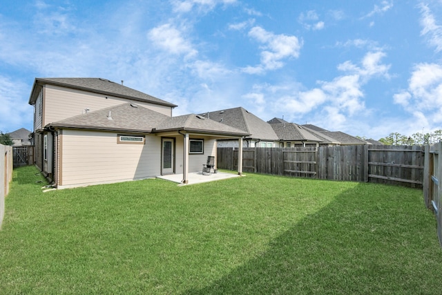 back of property with a lawn and a patio area