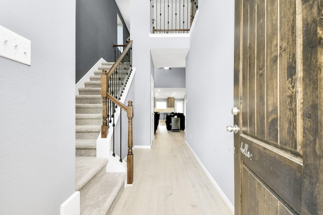 12810 Ilderton Dr, Humble, TX 77346 - entrance foyer with wood finished floors, baseboards, stairway, and a towering ceiling