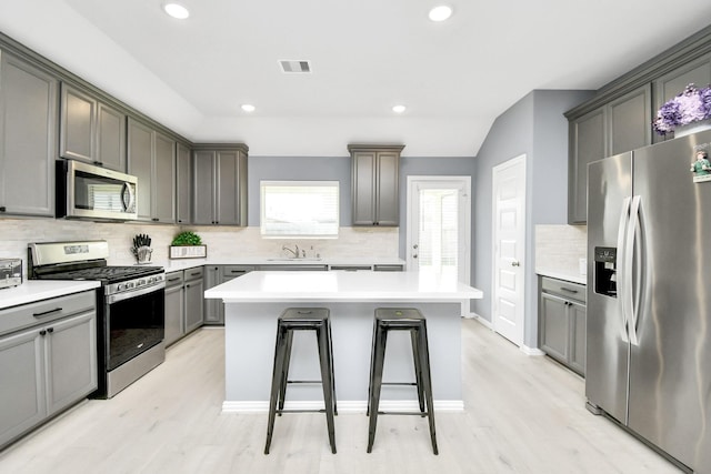 12810 Ilderton Dr, Humble, TX 77346 - kitchen featuring stainless steel appliances, a sink, backsplash, light wood-type flooring, and recessed lighting