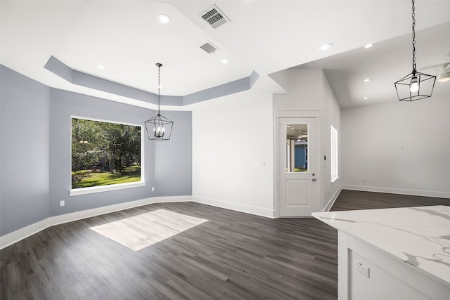 unfurnished dining area with a chandelier and dark wood-type flooring