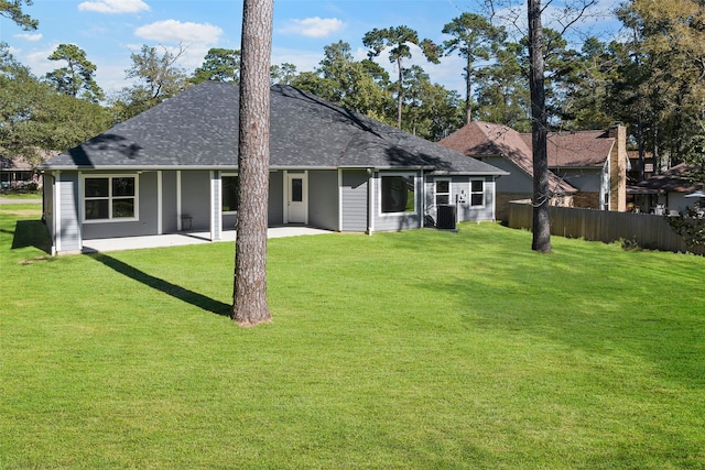 back of property featuring a patio area and a lawn