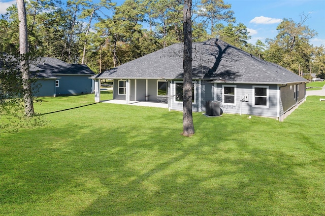 back of property with a patio area and a yard