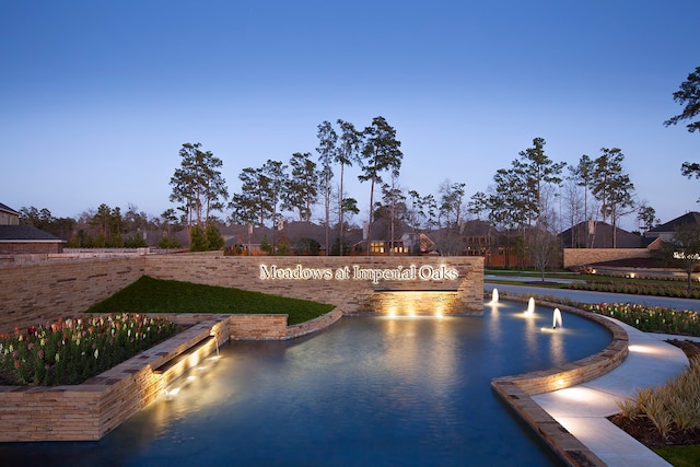 view of pool at dusk