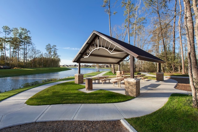 view of community featuring a yard and a water view