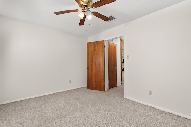 empty room with light carpet and ceiling fan