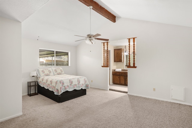 carpeted bedroom featuring lofted ceiling with beams, ensuite bath, and ceiling fan