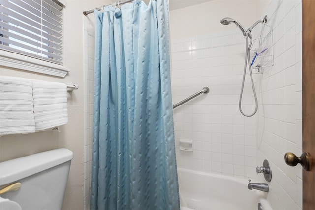 bathroom featuring shower / bath combo with shower curtain and toilet