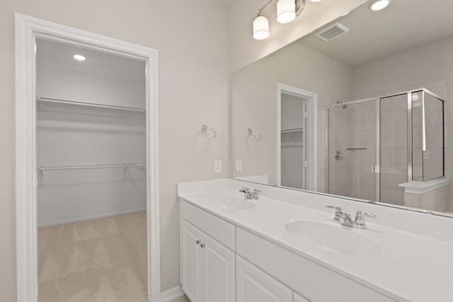 bathroom featuring vanity and an enclosed shower