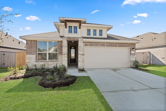 view of front of property featuring a front yard and a garage