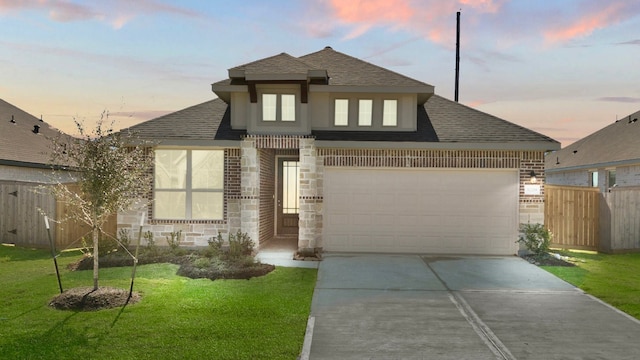 view of front of property with a yard and a garage