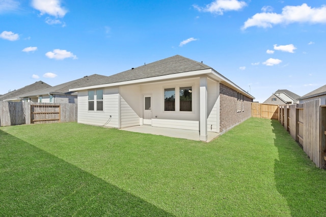 back of house featuring a yard and a patio