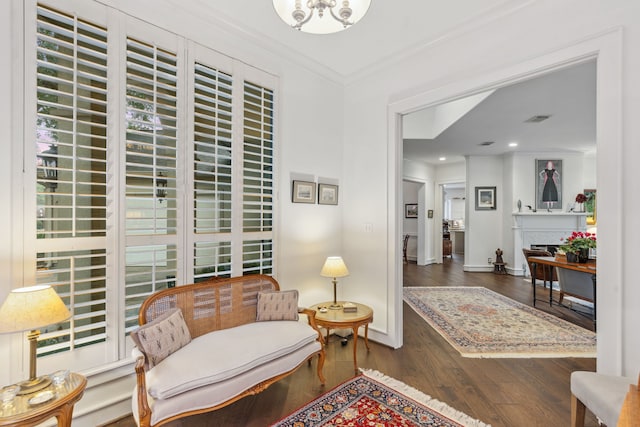 living area featuring dark hardwood / wood-style flooring and ornamental molding