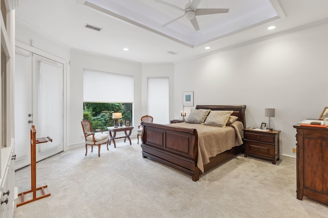 bedroom featuring light colored carpet, a raised ceiling, ceiling fan, and crown molding