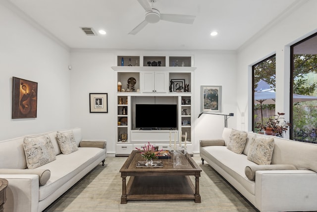 living room featuring ceiling fan and ornamental molding