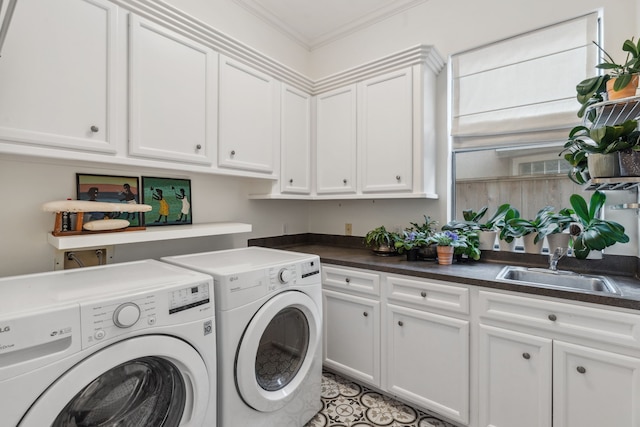 laundry room with sink, washer and dryer, cabinets, and crown molding