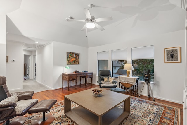 living room featuring wood-type flooring, vaulted ceiling, and ceiling fan