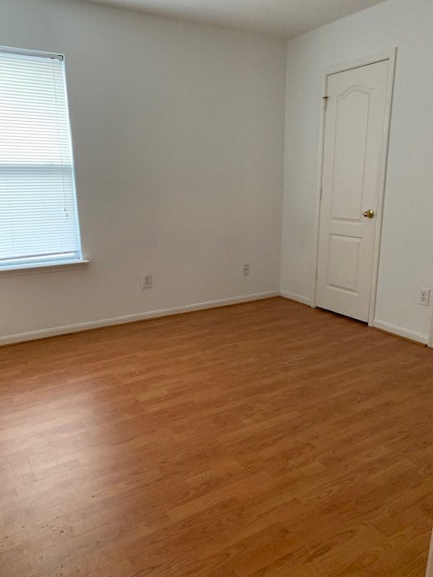 unfurnished room with light hardwood / wood-style floors