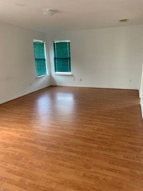 unfurnished room with light wood-type flooring