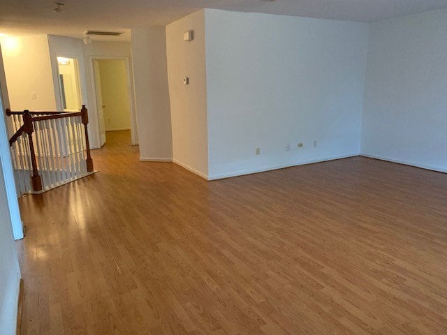 unfurnished room with hardwood / wood-style flooring