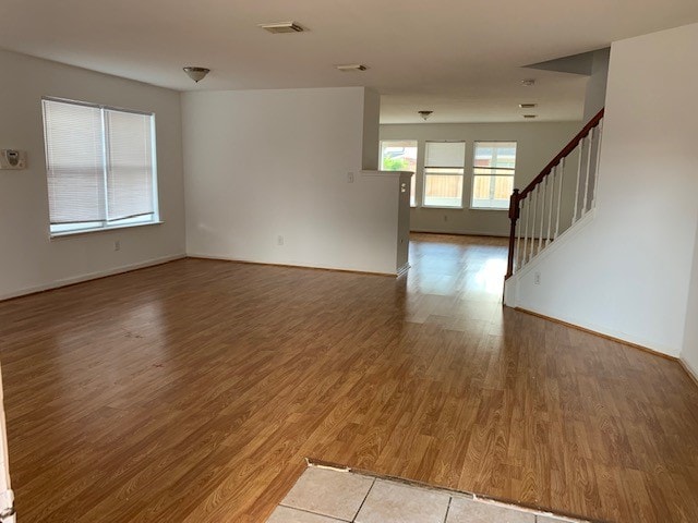 empty room with hardwood / wood-style floors