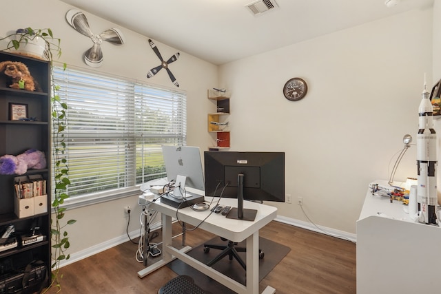 home office with dark wood-type flooring