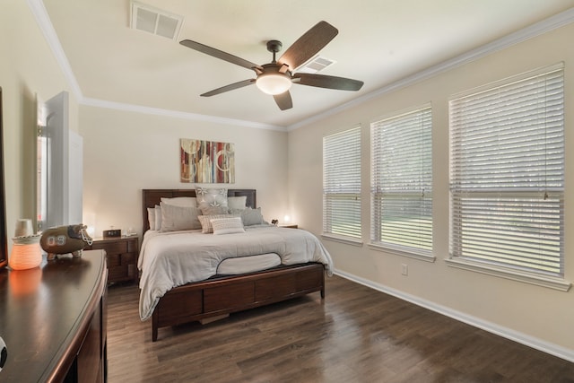 bedroom featuring dark wood-type flooring, ornamental molding, and ceiling fan