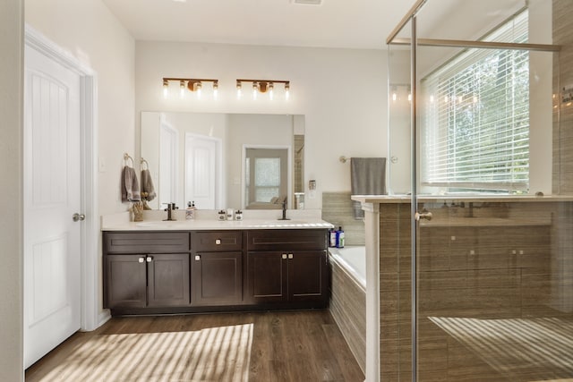 bathroom with vanity, plus walk in shower, and wood-type flooring