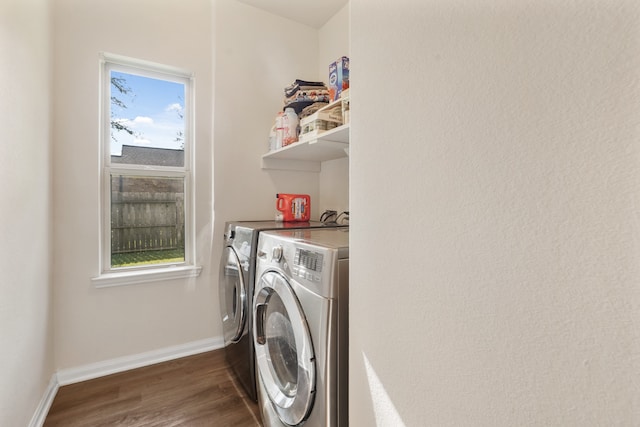 washroom with dark hardwood / wood-style flooring and washer and clothes dryer