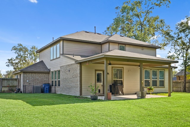 back of property featuring a patio and a lawn