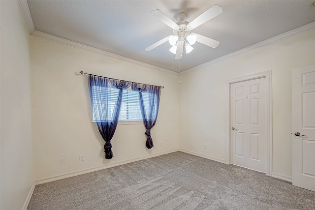 spare room featuring light carpet, ceiling fan, and ornamental molding