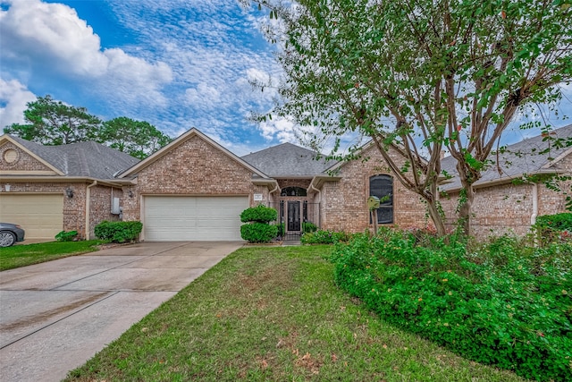 view of front of home with a garage and a front lawn