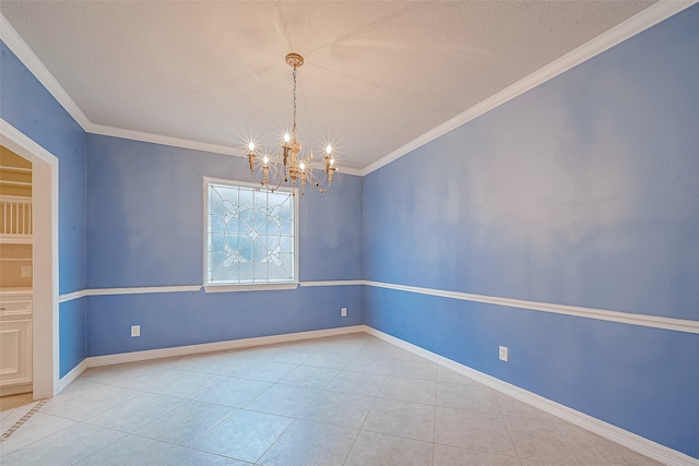 tiled empty room with a chandelier, a textured ceiling, and ornamental molding