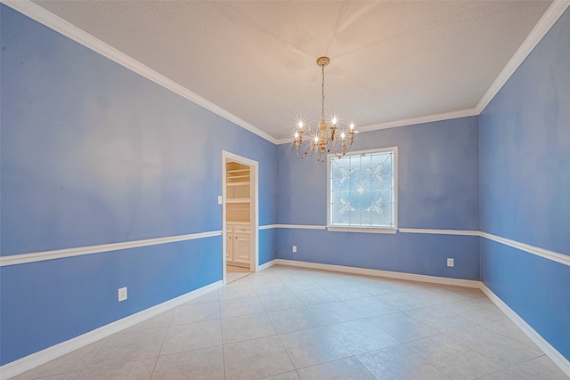 tiled empty room with a textured ceiling, crown molding, and a notable chandelier