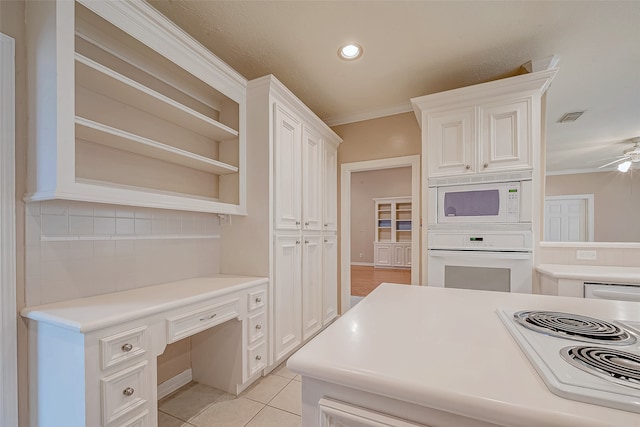 kitchen featuring white appliances, tasteful backsplash, white cabinetry, and crown molding