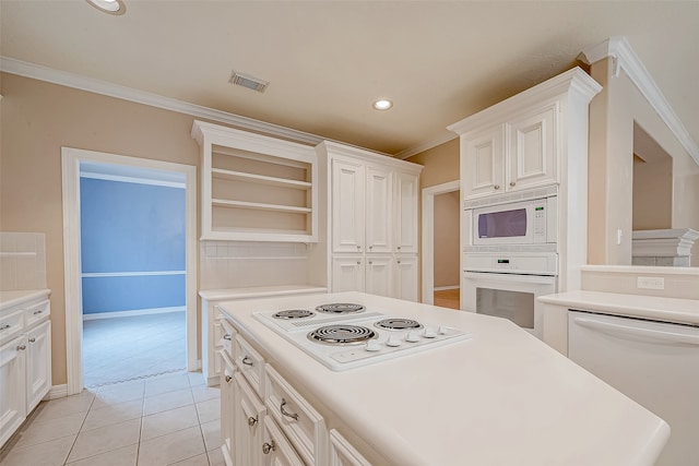 kitchen featuring white cabinets, light tile patterned floors, white appliances, and ornamental molding