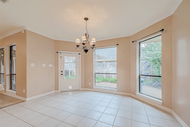 tiled spare room featuring plenty of natural light, crown molding, and a chandelier