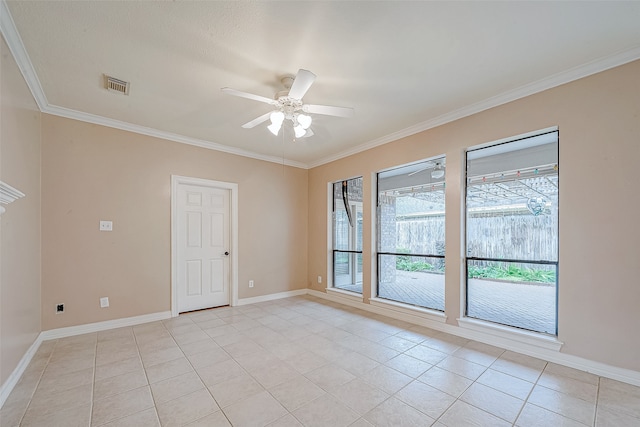 spare room with ceiling fan, ornamental molding, and light tile patterned floors