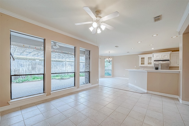 unfurnished living room with ceiling fan with notable chandelier, light tile patterned flooring, and ornamental molding